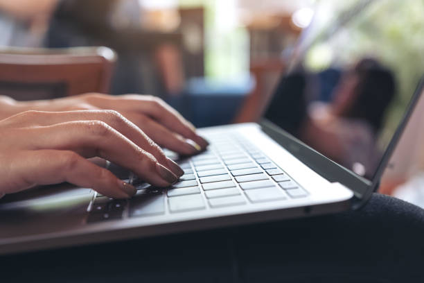 istock Closeup image of a woman's hands working and typing on laptop keyboard on table 996101460