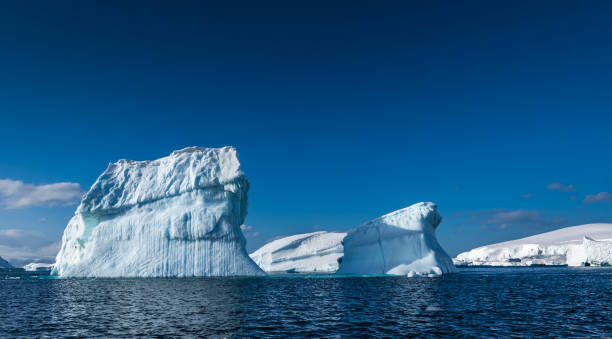 istock Two weather eroded icebergs in Wilhemina Bay Antarctica 996101910