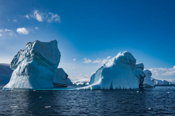 istock Two weather eroded icebergs in Wilhemina Bay Antarctica 996104082
