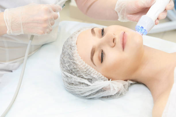 istock Microcurrent facial dermatology procedure. Model. Aesthetic radiofrequency treatment. Micro current cosmetology massage 996109048