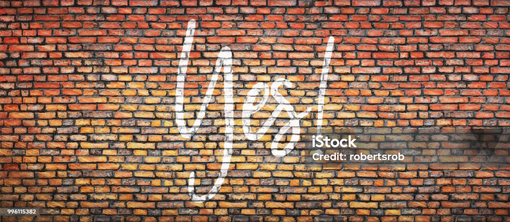 wall Brick wall with word yes. Concept background Ecstatic Stock Photo