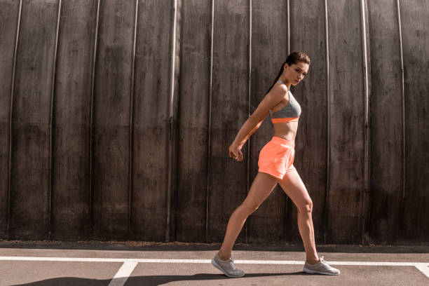 istock beautiful athletic woman exercising on parking 996115642