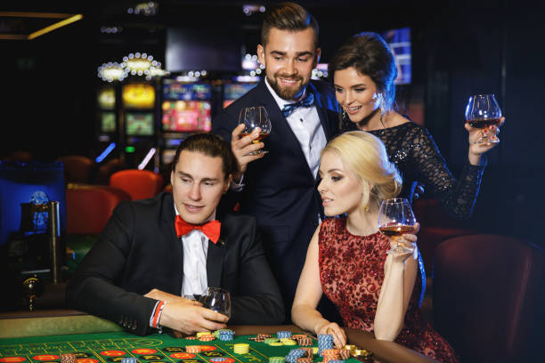 istock Young and rich people playing roulette in the casino 996128032