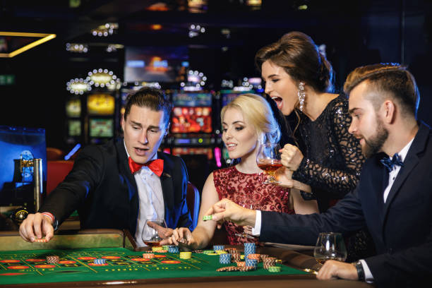 istock Young and rich people playing roulette in the casino 996128236