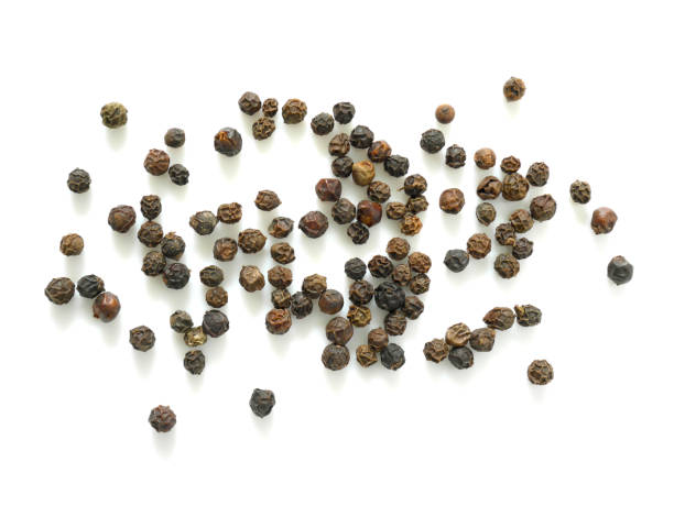 istock Pile of black peppercorns isolated on white background 996129490