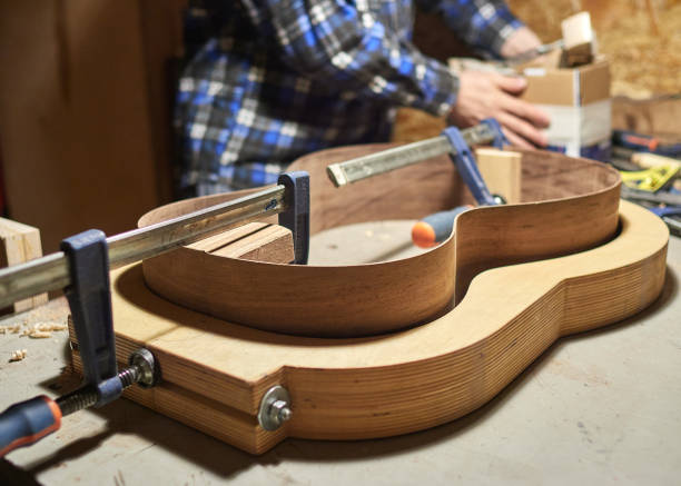 the process of making a classical guitar. adhering tailblock and neckblock guitars. - adhering imagens e fotografias de stock