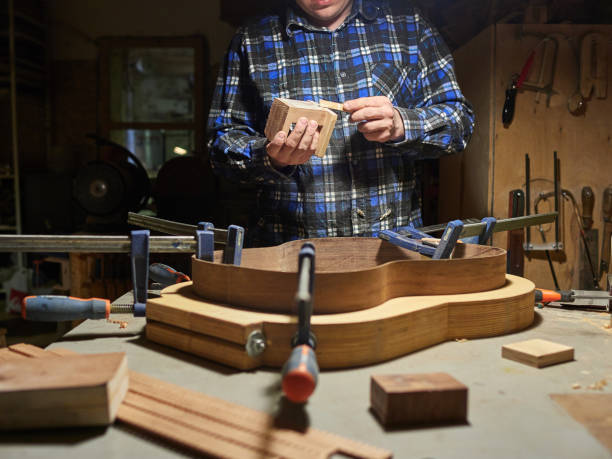 the process of making a classical guitar. adhering tailblock and neckblock guitars. - adhering imagens e fotografias de stock