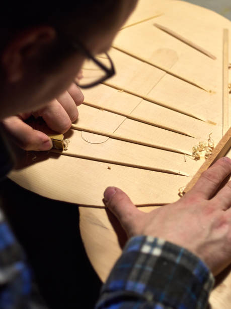 istock The process of making a classical guitar. Making the right shape of a brace guitar. 996132048