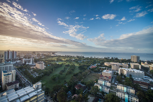A high angle view over downtown city Kivukoni district Dar es Salaam Business District  Coastline and public park with  Gymkhana Golf Course prior to sunset Tanzania