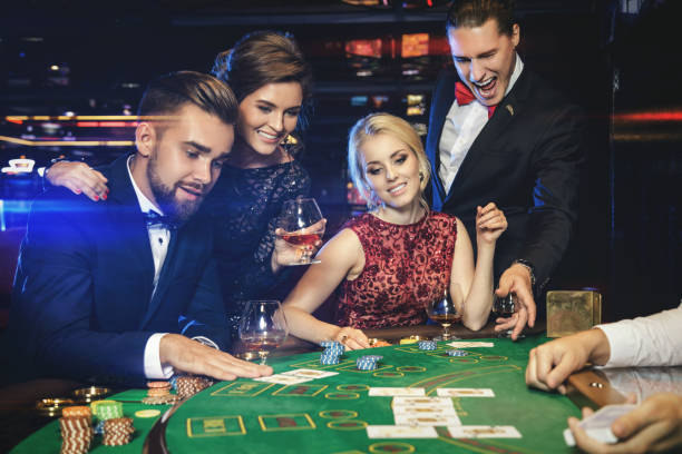 Group of rich people is playing poker in the casino Group of young rich people is playing poker in the casino texas hold em photos stock pictures, royalty-free photos & images