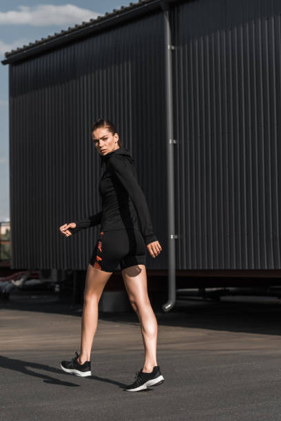 istock attractive sportswoman walking in black thermal clothes 996136854