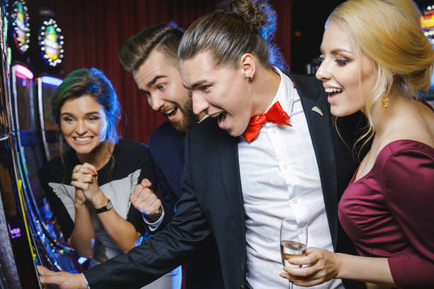 istock Group of friends playing slot machines 996137302