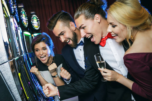 istock Group of friends playing slot machines 996137592