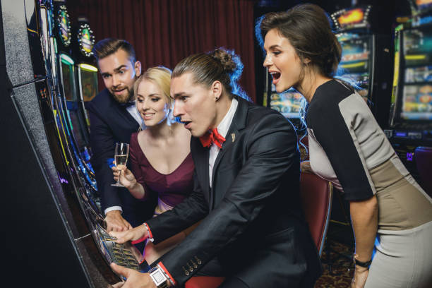 istock Group of friends playing slot machines 996137714