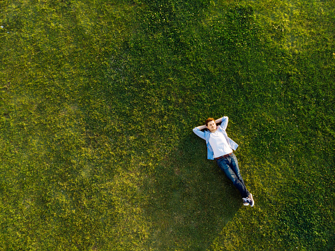 Relaxed young man sleeping on grass