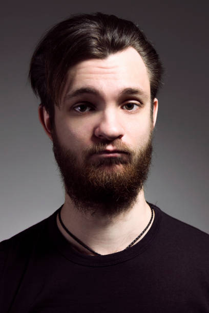 istock funny young man with long beard in black t-shirt 996159056