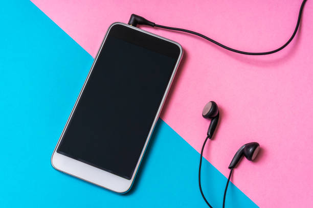 istock Mobile phone with headphones isolated on colorful background 996160342