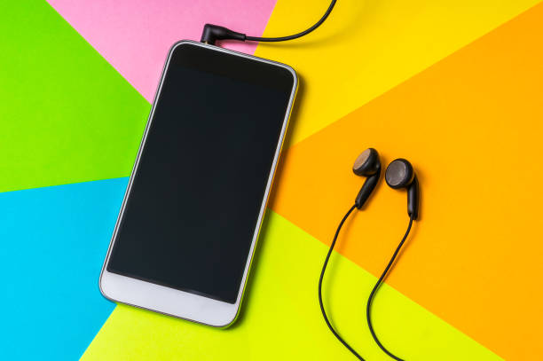 istock Mobile phone with headphones isolated on colorful background 996166614