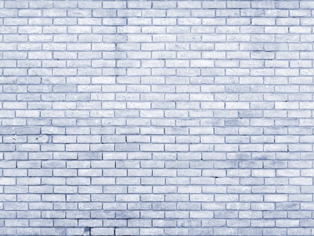 un pâle vieille brique mur fond bleu avec répétition motif - seamless brick repetition pattern photos et images de collection