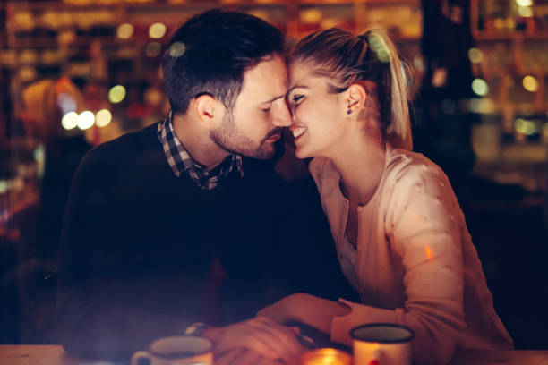 istock Romantic couple dating in pub at night 996168024