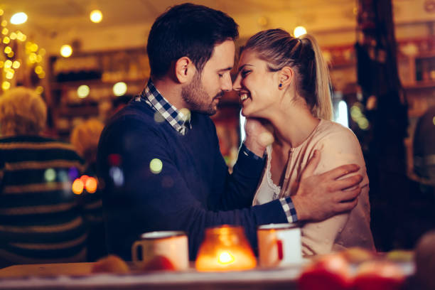 istock Romantic couple dating in pub at night 996168156