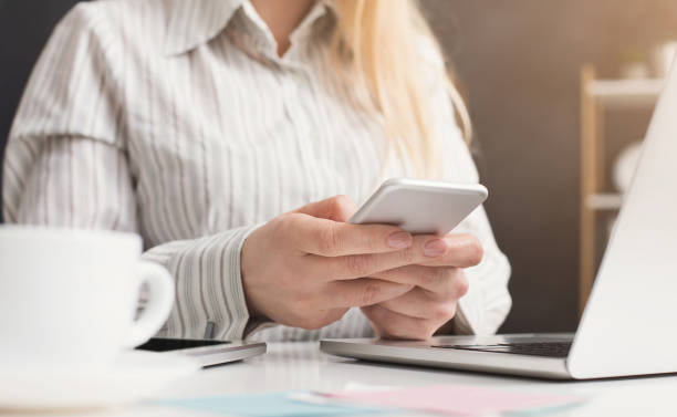 istock Woman manager holding smartphone at workplace 996171874