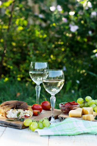 istock White wine and light snacks, Grapes, wine, cheese, pie. 996172350