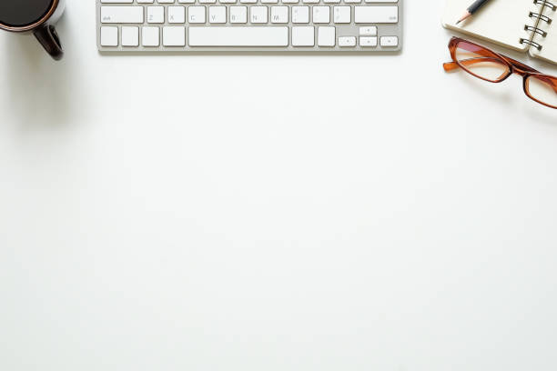 istock Top view office desk with computer, pencil, glasses, notebook paper and coffee cup. 996178660
