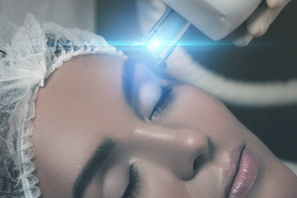 beautiful woman in  beauty salon during rejuvenation procedure - eyes narrowed imagens e fotografias de stock