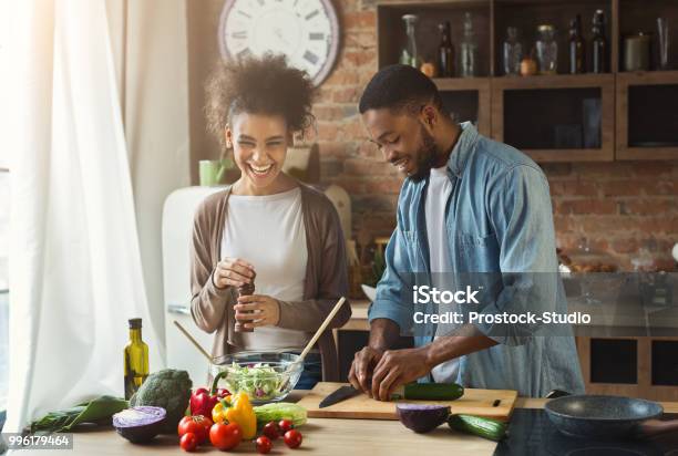 Laughing Black Couple Preparing Salad In Kitchen Stock Photo - Download Image Now - Cooking, Couple - Relationship, Healthy Eating