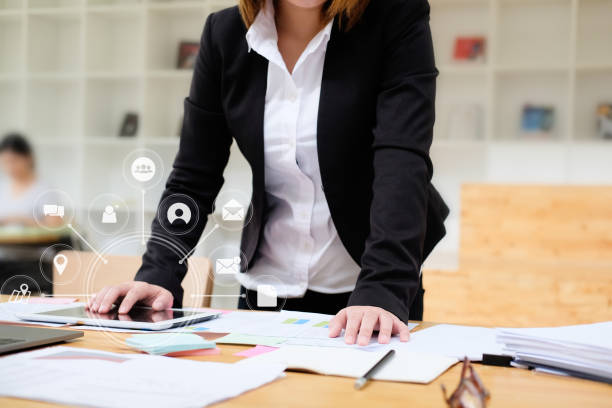 Business woman working with tablet computer analysis data of finance and visual icon technology.