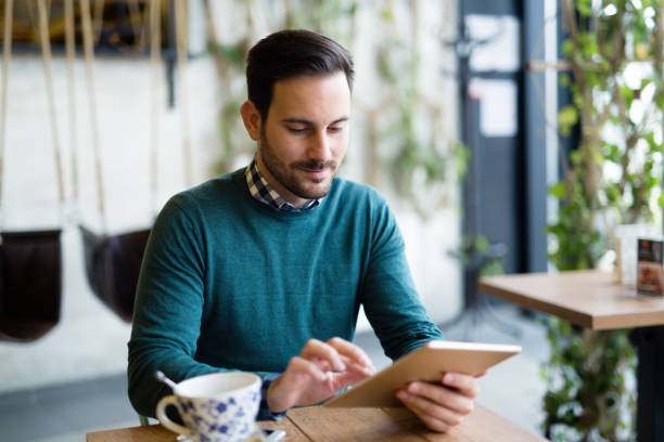 istock Portrait of young attractive man using tablet 996182534