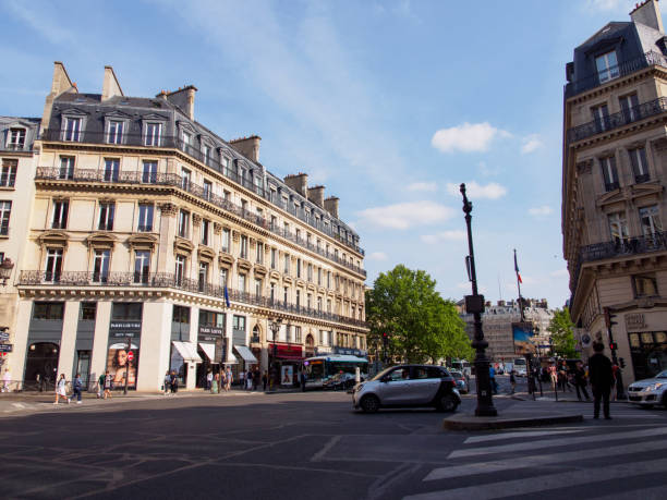 Intersection at Avenue de l'Opera, Paris, France PARIS, FRANCE - May 9, 2018: Wide angle view of an intersection between the Avenue de l'Opera and another street, with the shade of a late afternoon. Travel and urban lifestyle editorial. place de lopera stock pictures, royalty-free photos & images