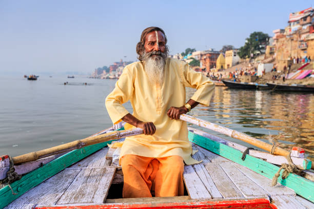 istock Sadhu rowing boat on the holy Ganges River in Varanasi 996190724