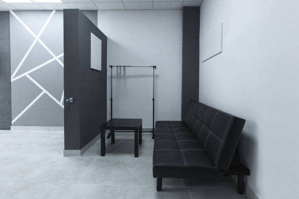 istock Interior with couch clock and pictures on walls , creative workspace with concrete elements 996193924