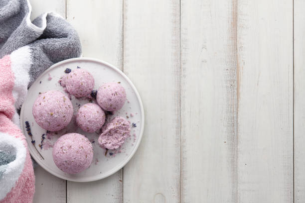 istock Handmade lavender bath bombs and flowers on white table 996194744