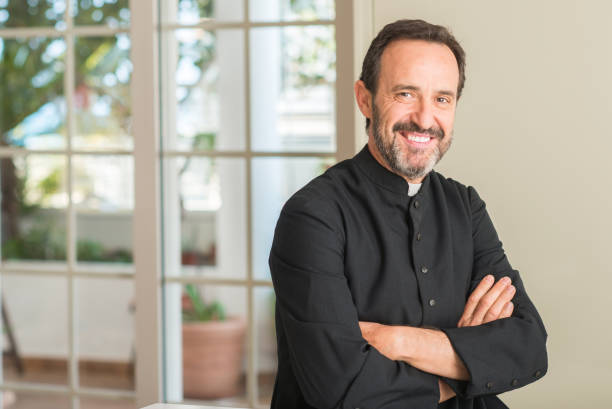 Christian priest man with a happy face standing and smiling with a confident smile showing teeth Christian priest man with a happy face standing and smiling with a confident smile showing teeth priest photos stock pictures, royalty-free photos & images
