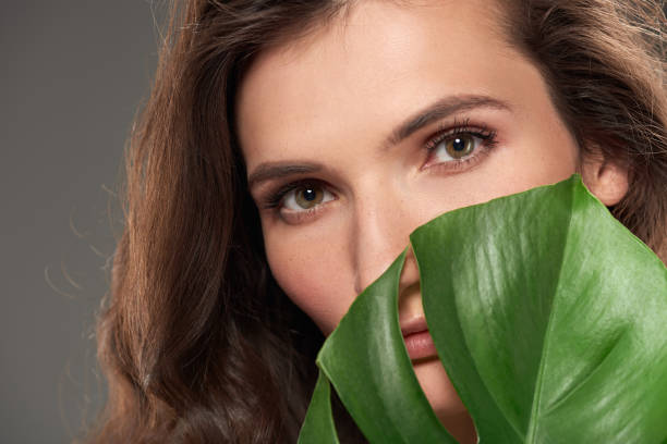 istock beautiful elegant girl with monstera leaf, isolated on grey 996205584