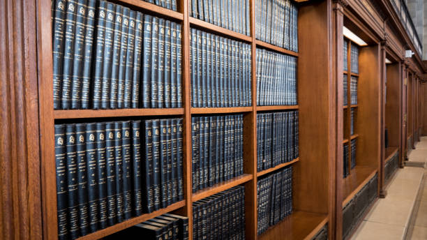 Row of books in the library, wooden shelves