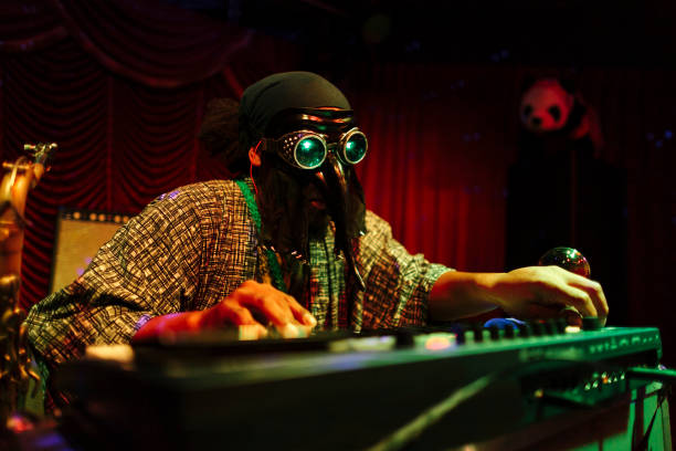 Man with mask playing music on stage