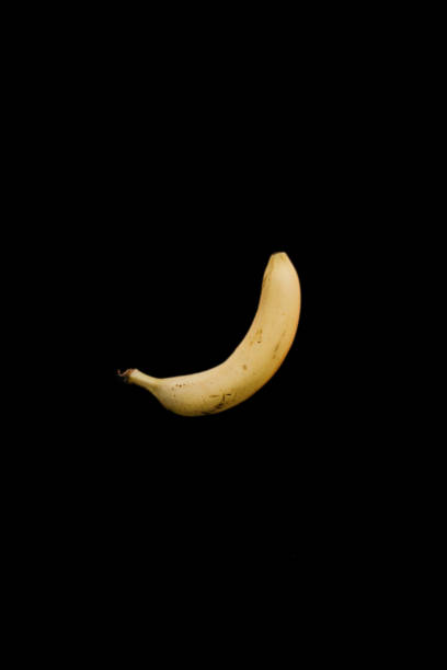 istock Single yellow ripe banana on a black background 996227198