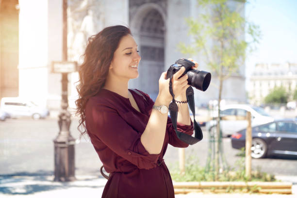 istock young woman walks in Paris (with a camera) 996230700