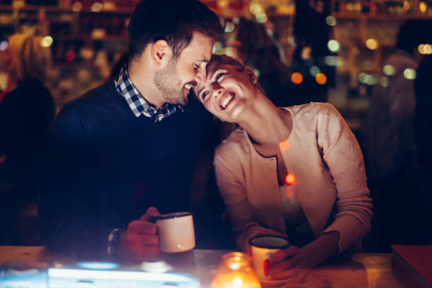 istock Romantic couple dating in pub at night 996232292