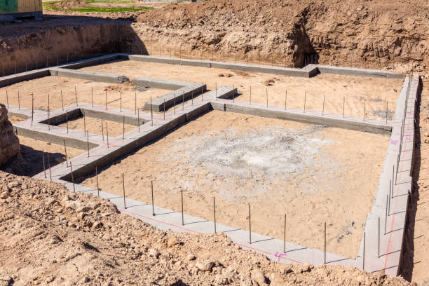 Reinforced concrete foundations on newly prepared land for house building.
