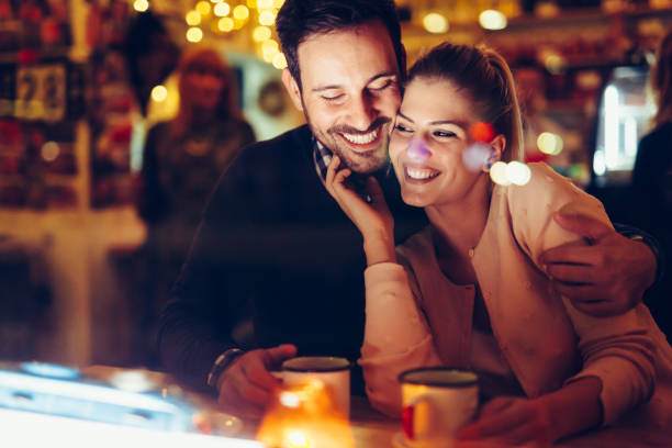 istock Romantic couple dating in pub at night 996232384