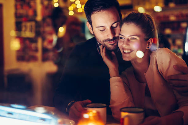 istock Romantic couple dating in pub at night 996232472