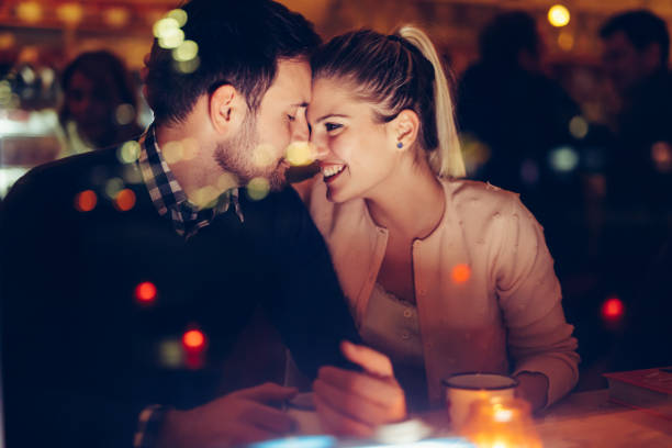 romantic couple dating in pub at night - dating restaurant dinner couple imagens e fotografias de stock