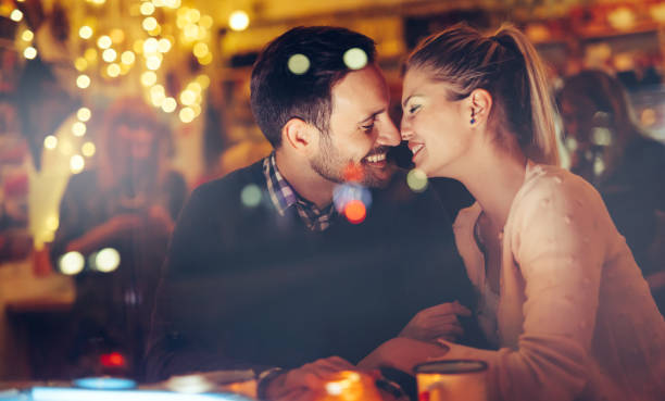 istock Romantic couple dating in pub at night 996232668
