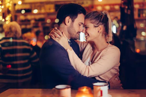 istock Romantic couple dating in pub at night 996234180