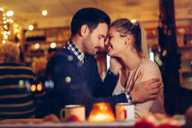 istock Romantic couple dating in pub at night 996234990